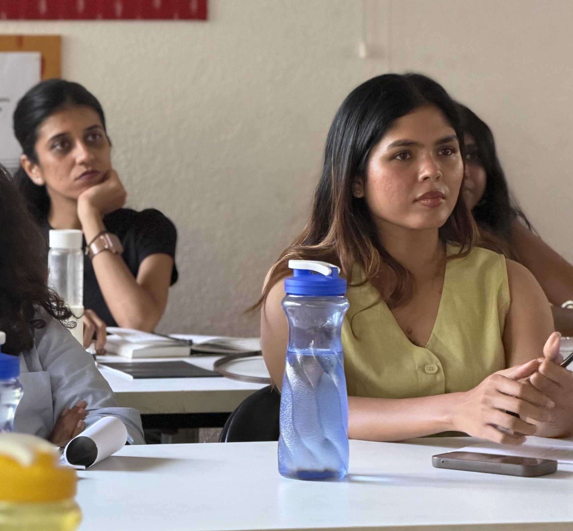 Three women in conversation at a talk session